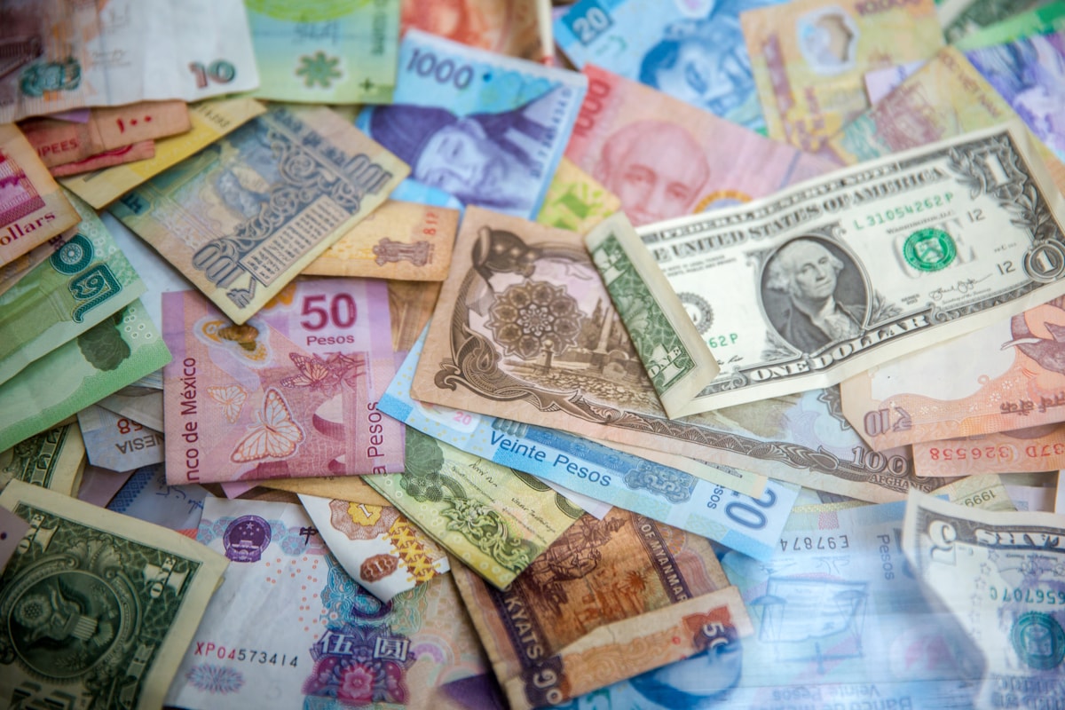 Mixed international currencies including Mexican pesos and US dollars